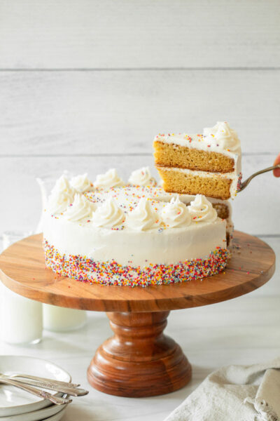 Gluten-Free Vanilla Cake is the perfect gluten-free birthday cake and a great gluten-free holiday cake. This gluten-free cake recipe is made with layers of moist and spongy gluten-free vanilla cake frosted with creamy buttercream frosting. This gluten-free dessert recipe is an easy homemade cake recipe that will impress your friends and family. I am not lying when I tell you that most people are shocked when I tell them this cake is gluten-free, because you would never guess it is!