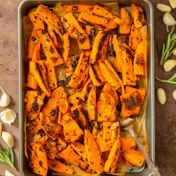 These Roasted Sweet Potato Wedges are crispy oven-roasted sweet potatoes seasoned with salt, garlic, onion and rosemary for the perfect easy side dish recipe. This sweet potato side dish is perfect for an easy weeknight meal and also great for meal prep.