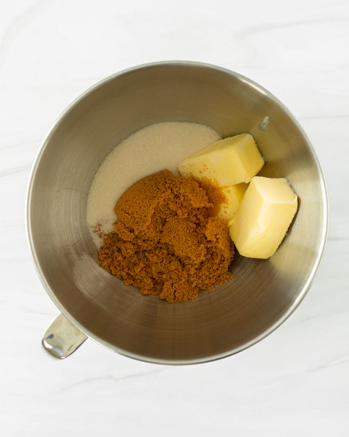 Step 1. Add the butter, cane sugar and brown sugar to a bowl