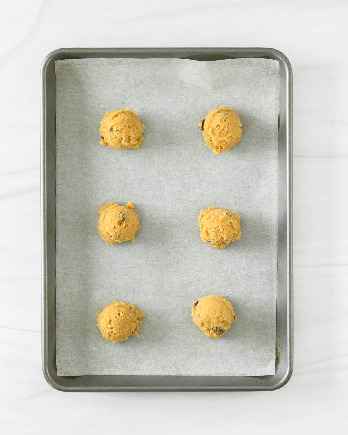 Step 11. Remove the chilled dough from the fridge & use a cookie scoop to form the dough into balls._