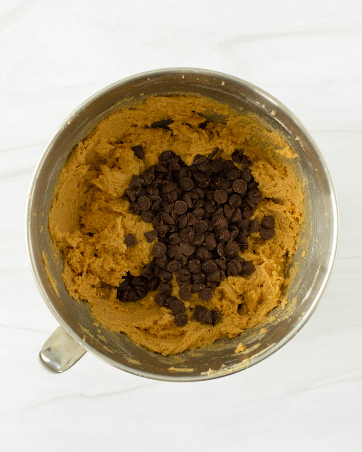 Step 9. Pour the chocolate chips into the bowl and fold them into the cookie dough