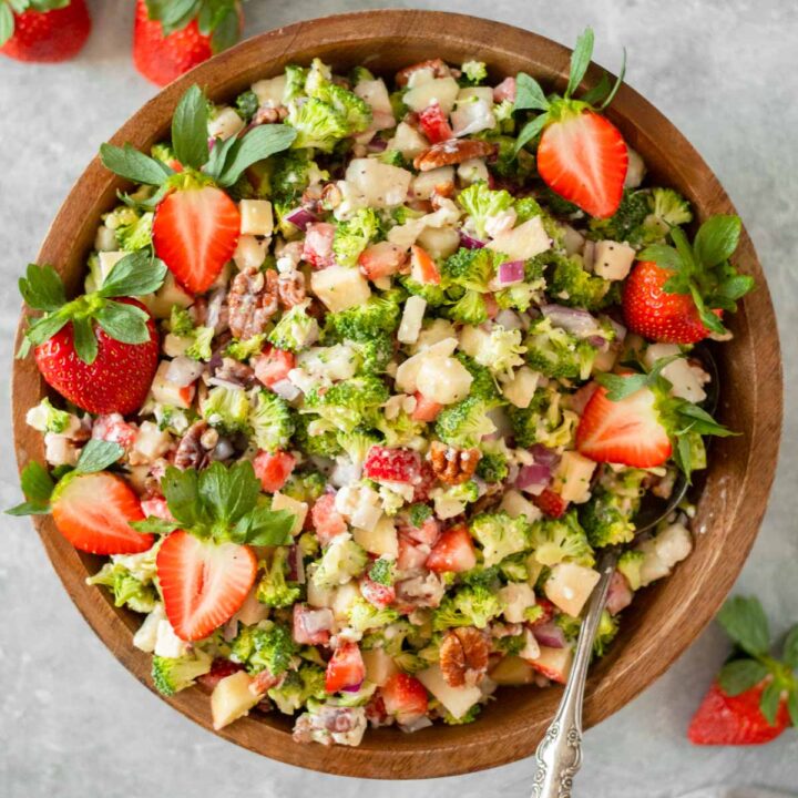 This strawberry broccoli salad is the perfect healthy salad recipe and easy side dish made with chopped broccoli and fruit mixed together in with a creamy poppy seed dressing. This salad is the perfect dish to bring to a holiday dinner, potluck or summer cookout.