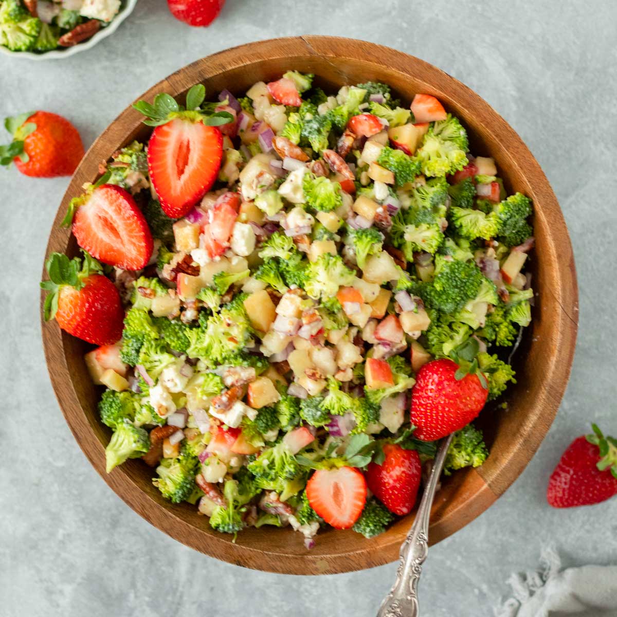 This strawberry broccoli salad is the perfect healthy salad recipe and easy side dish made with chopped broccoli and fruit mixed together in with a creamy poppy seed dressing. This salad is the perfect dish to bring to a holiday dinner, potluck or summer cookout.