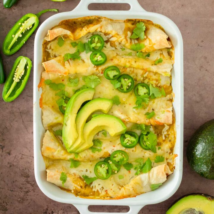 These salsa verde pork carnitas enchiladas are one of our most popular dinner recipes because this easy dinner recipe is the perfect quick, healthy and filling meal. These enchiladas are loaded with crockpot pork carnitas and cheese then baked in delicious sauce for the perfect comfort food any time of year.