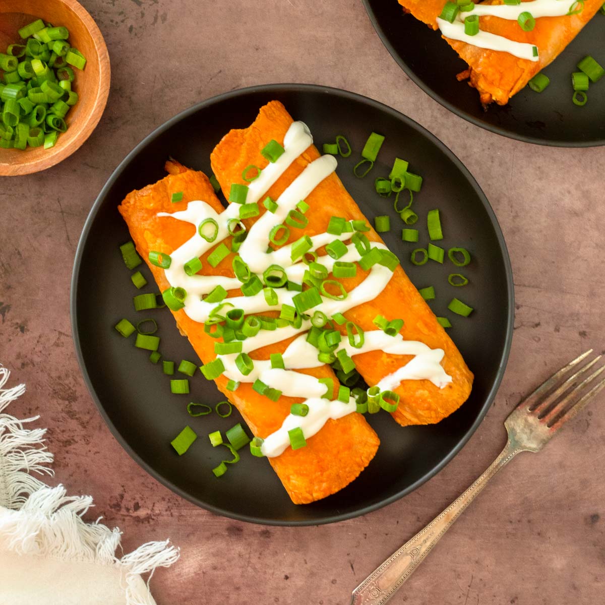 These buffalo chicken taquitos are an easy 5-ingredient dinner recipe. Stuffed with creamy buffalo chicken and cheese, these taquitos are baked until crispy for a delicious meal.