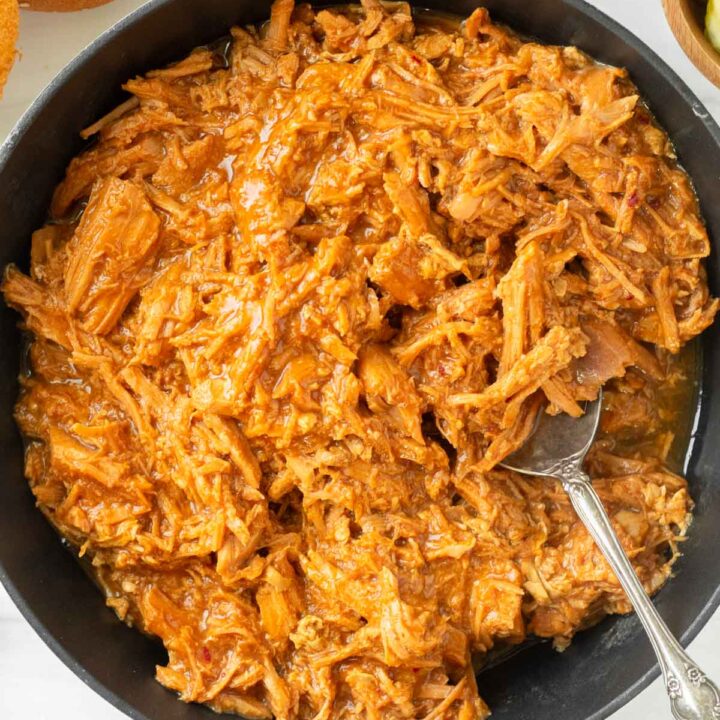 This crockpot BBQ pulled pork recipe is a great slower cooker pork recipe made with crockpot pulled pork and a tangy and sweet barbeque sauce for easy weeknight dinners and delicious summer cookouts.