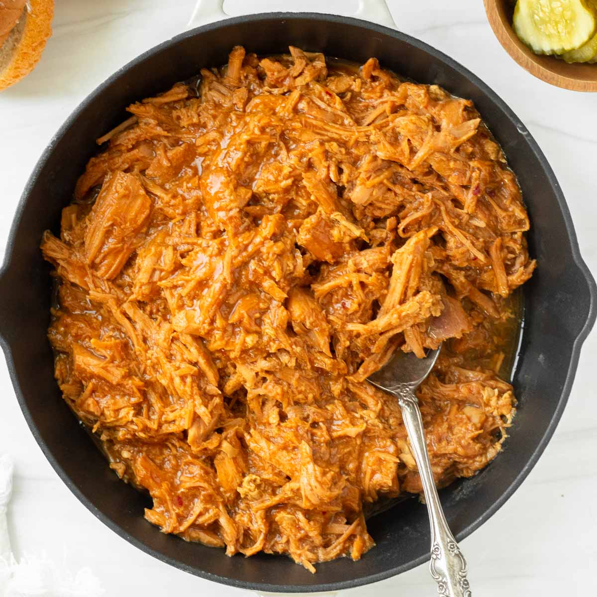 This crockpot BBQ pulled pork recipe is a great slower cooker pork recipe made with crockpot pulled pork and a tangy and sweet barbeque sauce for easy weeknight dinners and delicious summer cookouts.