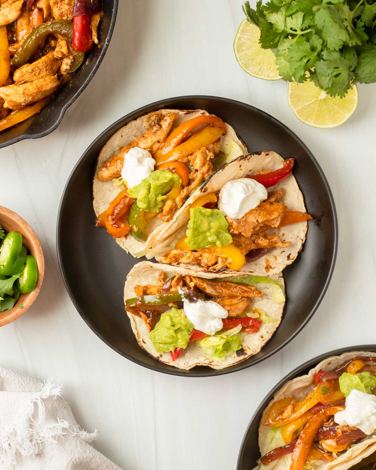 These chicken fajitas are a one-pan dinner made with chicken and vegetables cooked in a homemade fajita sauce and served in a tortilla and your favorite fajita toppings.