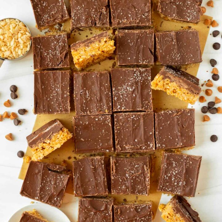 These classic scotcharoos are peanut butter crispy cereal bars made without corn syrup and topped with a thick layer of melted chocolate and butterscotch chips. This easy no-bake dessert is perfect for serving at a party or potluck and a great addition to a holiday meal.