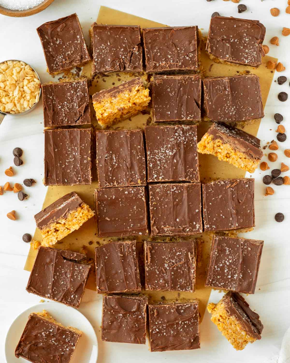 These classic scotcharoos are peanut butter crispy cereal bars made without corn syrup and topped with a thick layer of melted chocolate and butterscotch chips. This easy no-bake dessert is perfect for serving at a party or potluck and a great addition to a holiday meal.