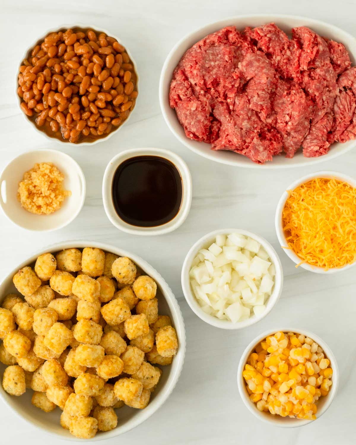 This cowboy tater tot casserole is an easy one-pan dinner recipe made with ground beef mixed with baked beans and corn and topped with cheese and tater tots. We love this easy kid-friendly dinner for a quick weeknight meal.