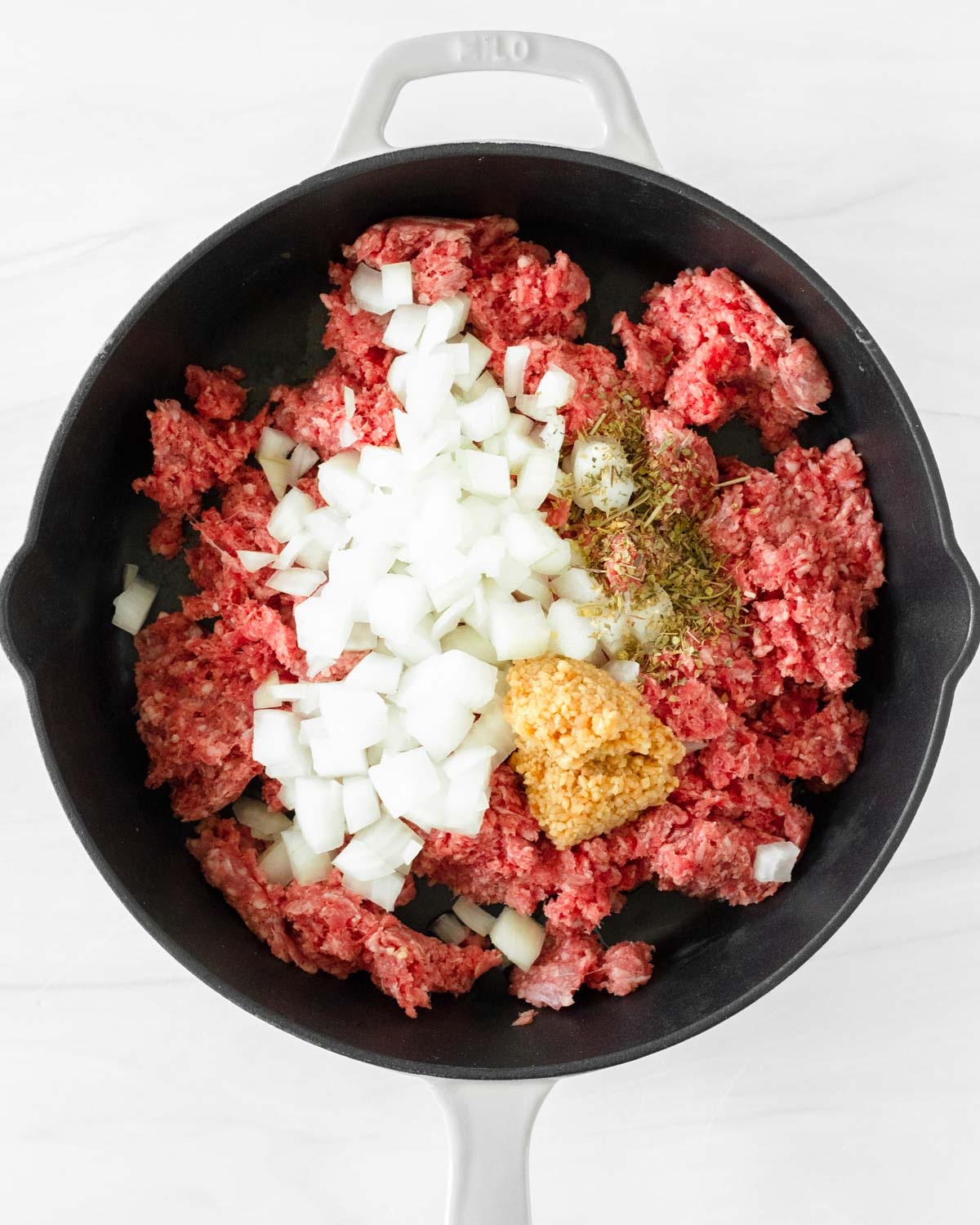 Step 1. Add the ground beef, diced onion, garlic and Italian seasoning to the skillet