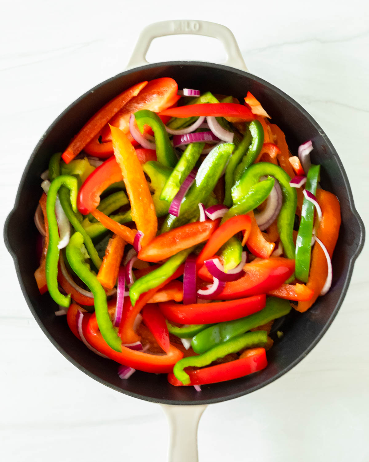 Step 1. Add the peppers, onion and oil to the skillet