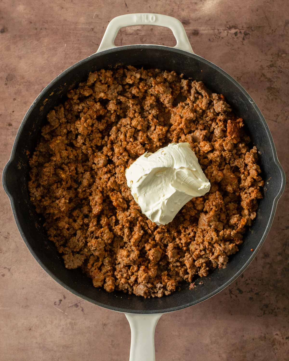 Step 3. Add cream cheese and stir to allow it to melt into the beef