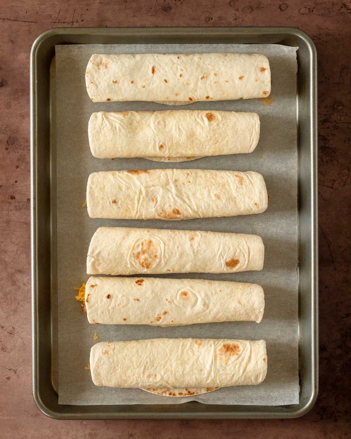 Step 6. Line the taquitos on a sheet pan