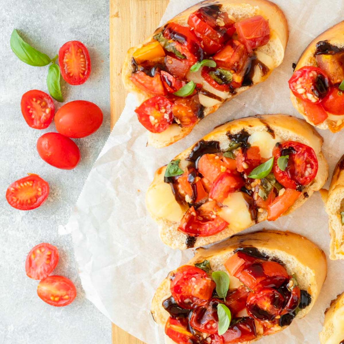 This baked bruschetta is an easy appetizer recipe made with bread topped with creamy mozzarella cheese and a fresh and flavorful mixture of tomatoes, basil and balsamic. This dish is perfect for a holiday appetizer, easy summer recipe and a great Fourth of July cookout recipe.