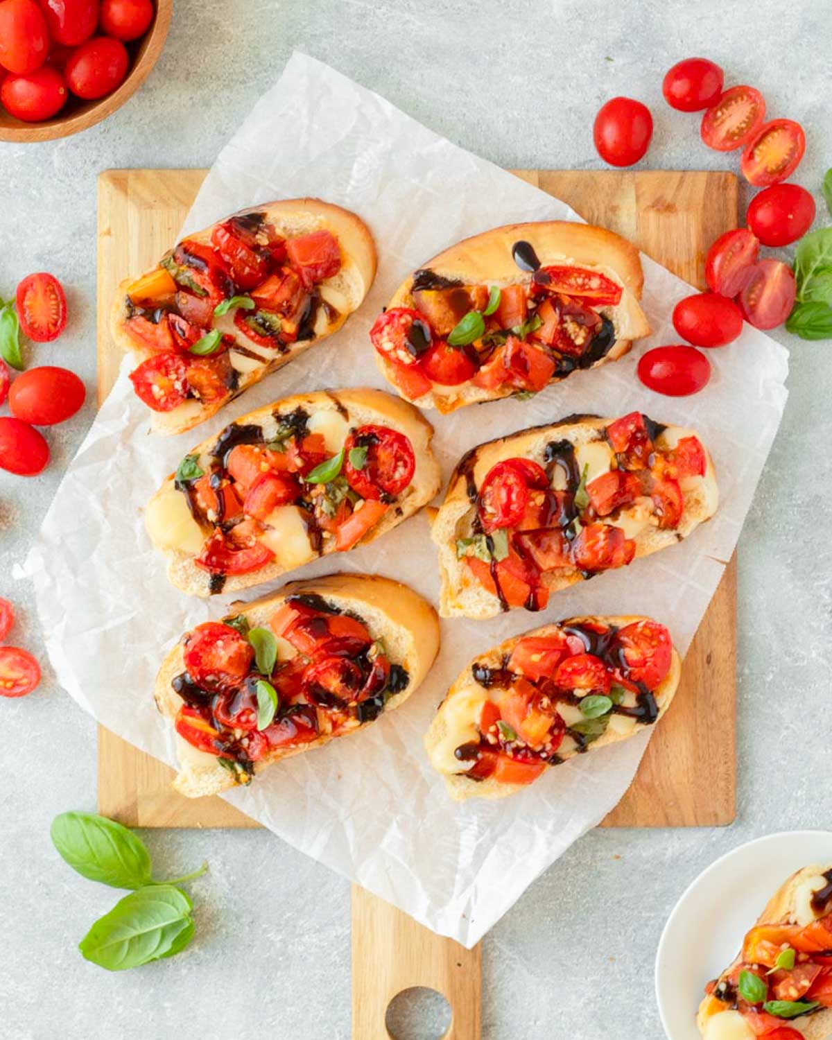 This baked bruschetta is an easy appetizer recipe made with bread topped with creamy mozzarella cheese and a fresh and flavorful mixture of tomatoes, basil and balsamic. This dish is perfect for a holiday appetizer, easy summer recipe and a great Fourth of July cookout recipe.