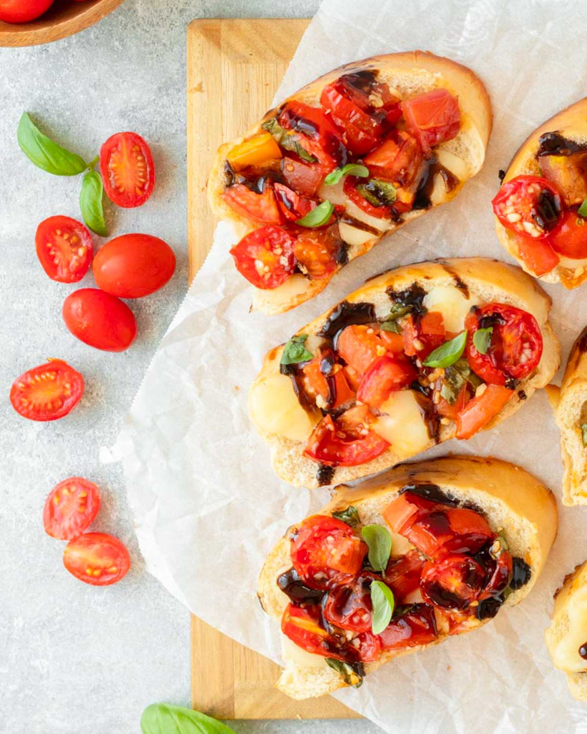 This baked bruschetta is an easy appetizer recipe made with bread topped with creamy mozzarella cheese and a fresh and flavorful mixture of tomatoes, basil and balsamic. This dish is perfect for a holiday appetizer, easy summer recipe and a great Fourth of July cookout recipe.