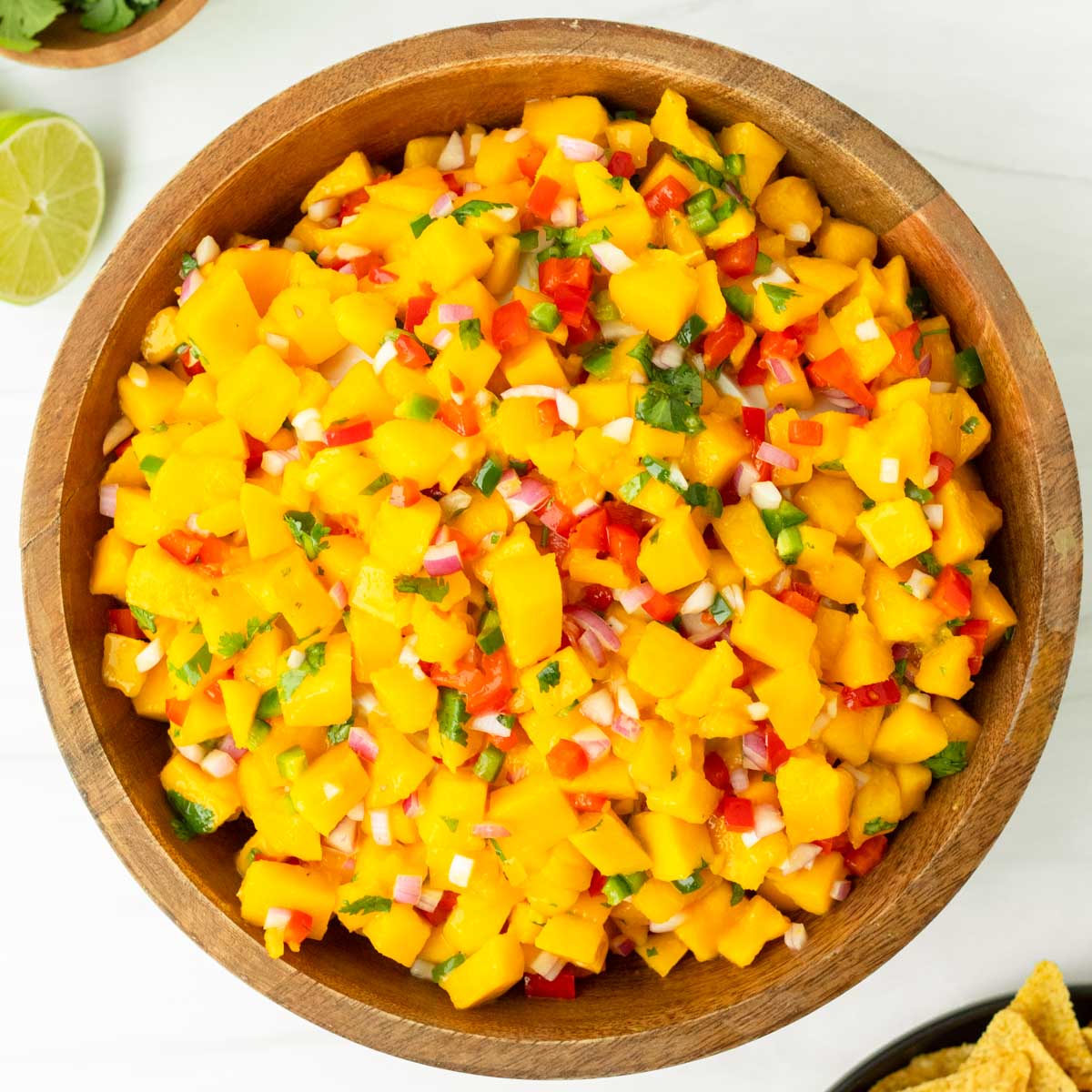 This mango salsa is an easy 6-ingredient salsa recipe perfect for a summer cookout or as a Fourth of July appetizer. Made with simple, flavorful ingredients, this homemade salsa is an easy and delicious summer dish.