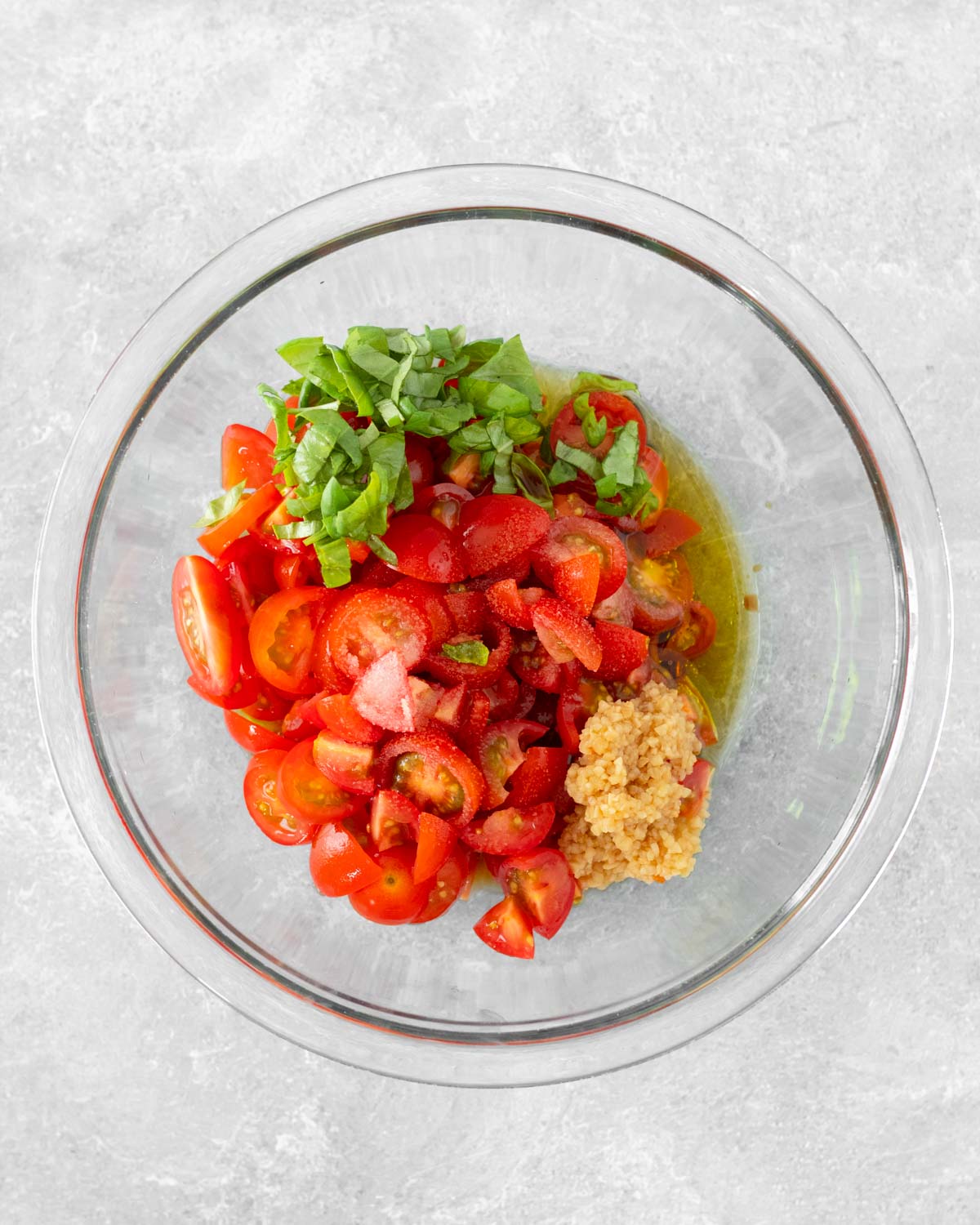 Step 1. Add the tomatoes, basil, oil, balsamic vinegar, garlic and salt to a bowl