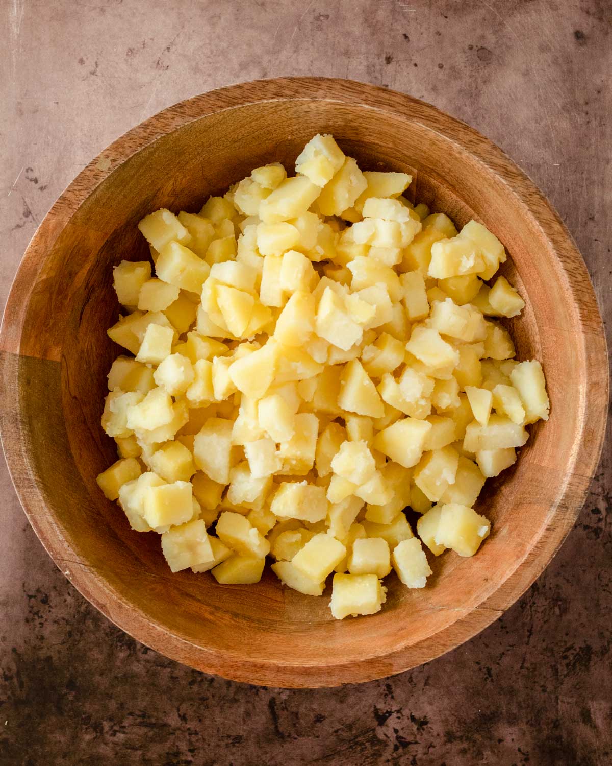 Step 1. Chop the potatoes into small cubes and boil until fork-tender, then transfer to a bowl