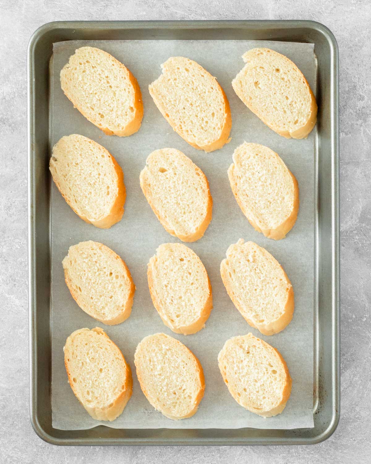 Step 3. Place the sliced bread on a sheet pan