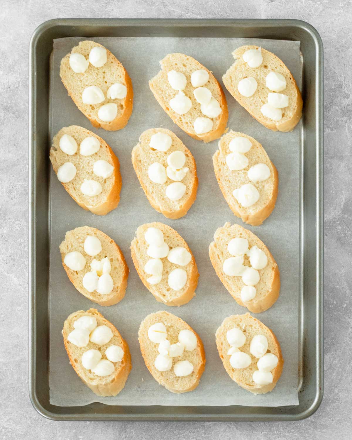 Step 4. Add the mozzarella pearls on top of slices of bread