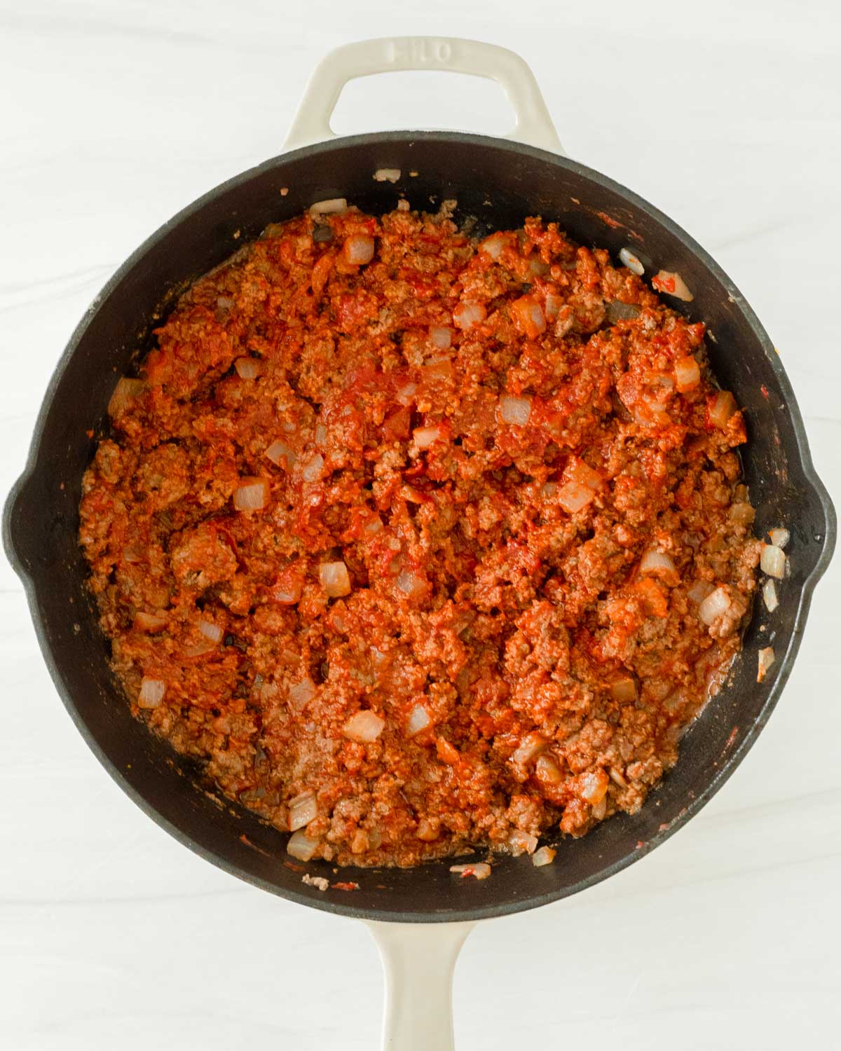 Step 4. Stir the tomato paste into the beef