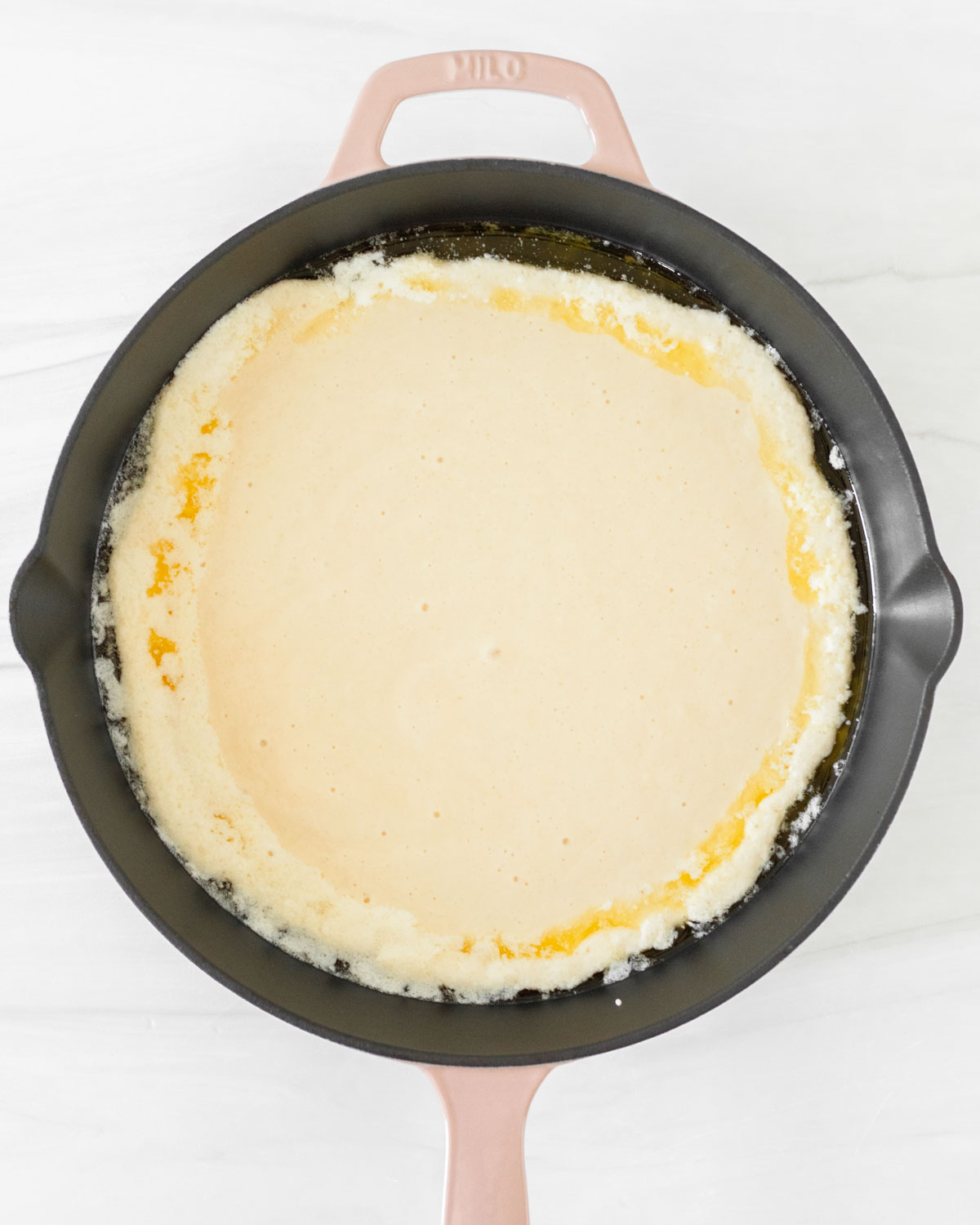 Step 8. Pour the batter into the skillet with the butter