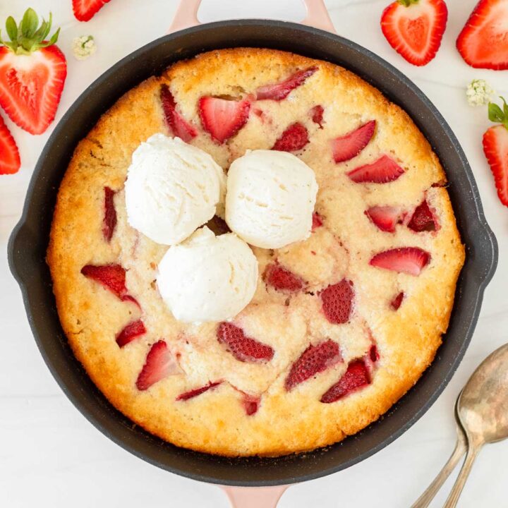 This strawberry cobbler is an easy summer dessert recipe that combines fresh-picked strawberries with a creamy batter to make a delicious one-skillet dessert.