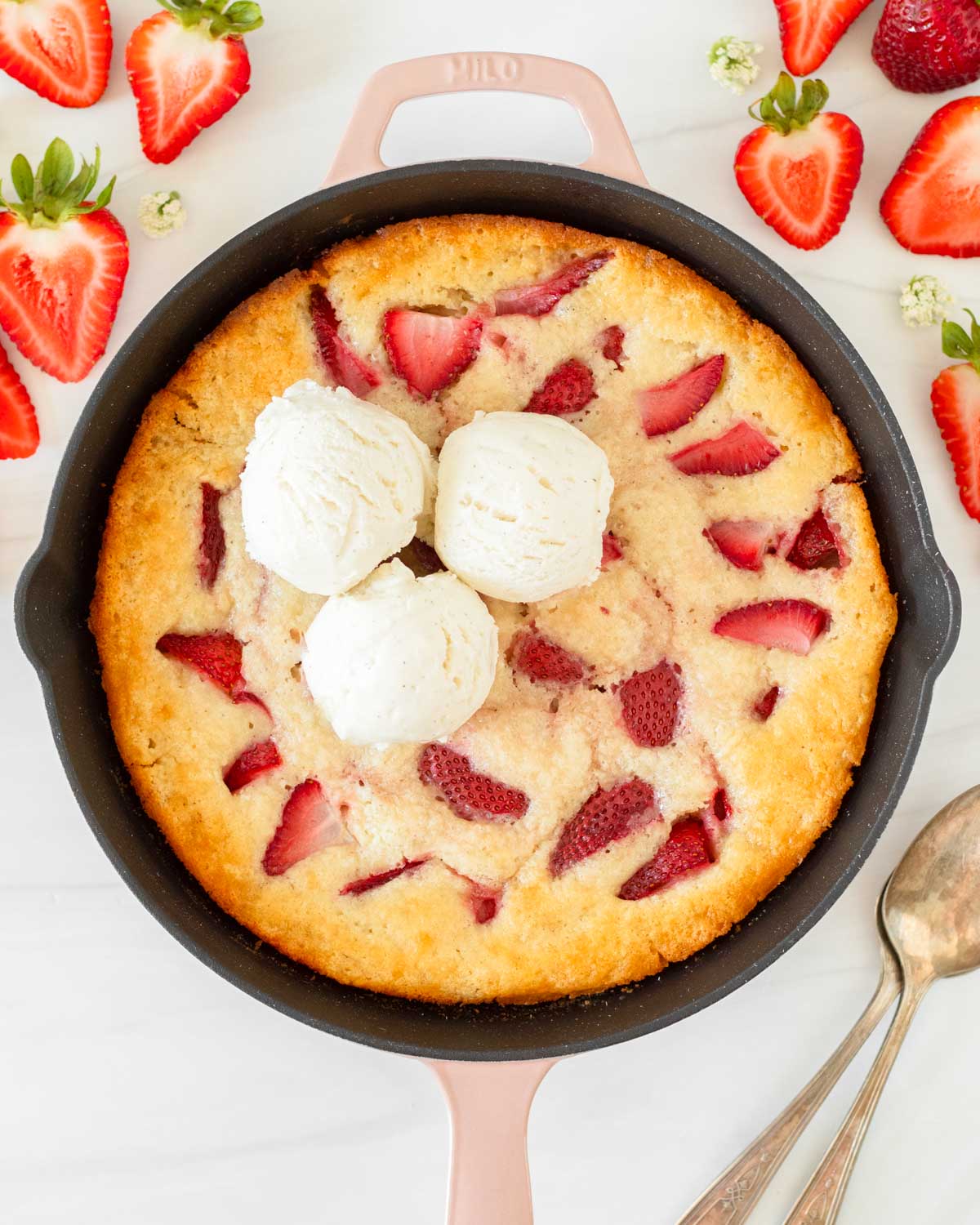 This strawberry cobbler is an easy summer dessert recipe that combines fresh-picked strawberries with a creamy batter to make a delicious one-skillet dessert.