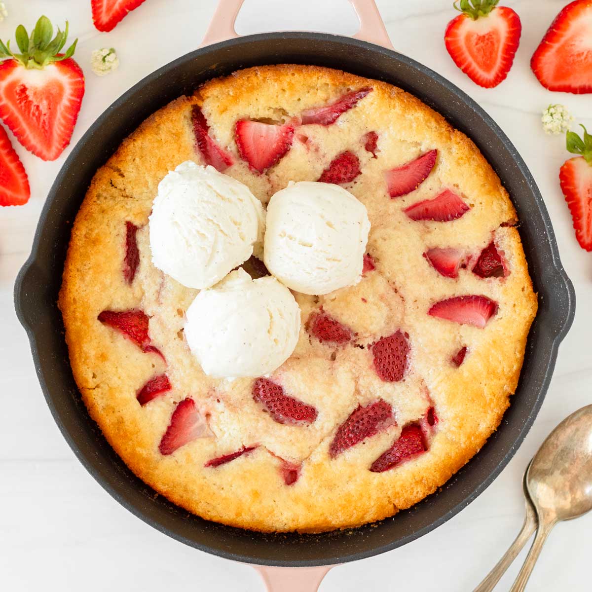 This strawberry cobbler is an easy summer dessert recipe that combines fresh-picked strawberries with a creamy batter to make a delicious one-skillet dessert.