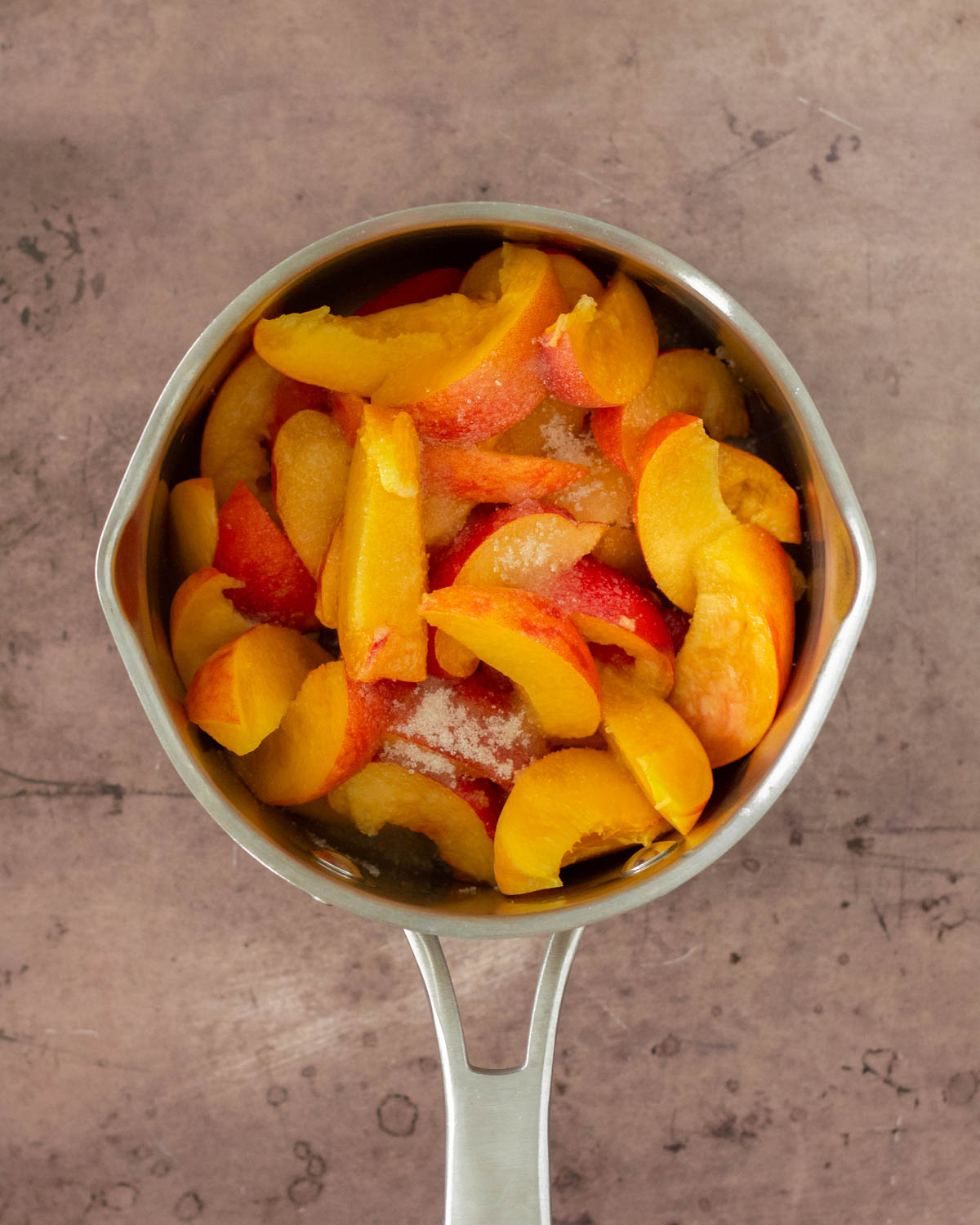 Step 1. Add the peaches and sugar to a pot