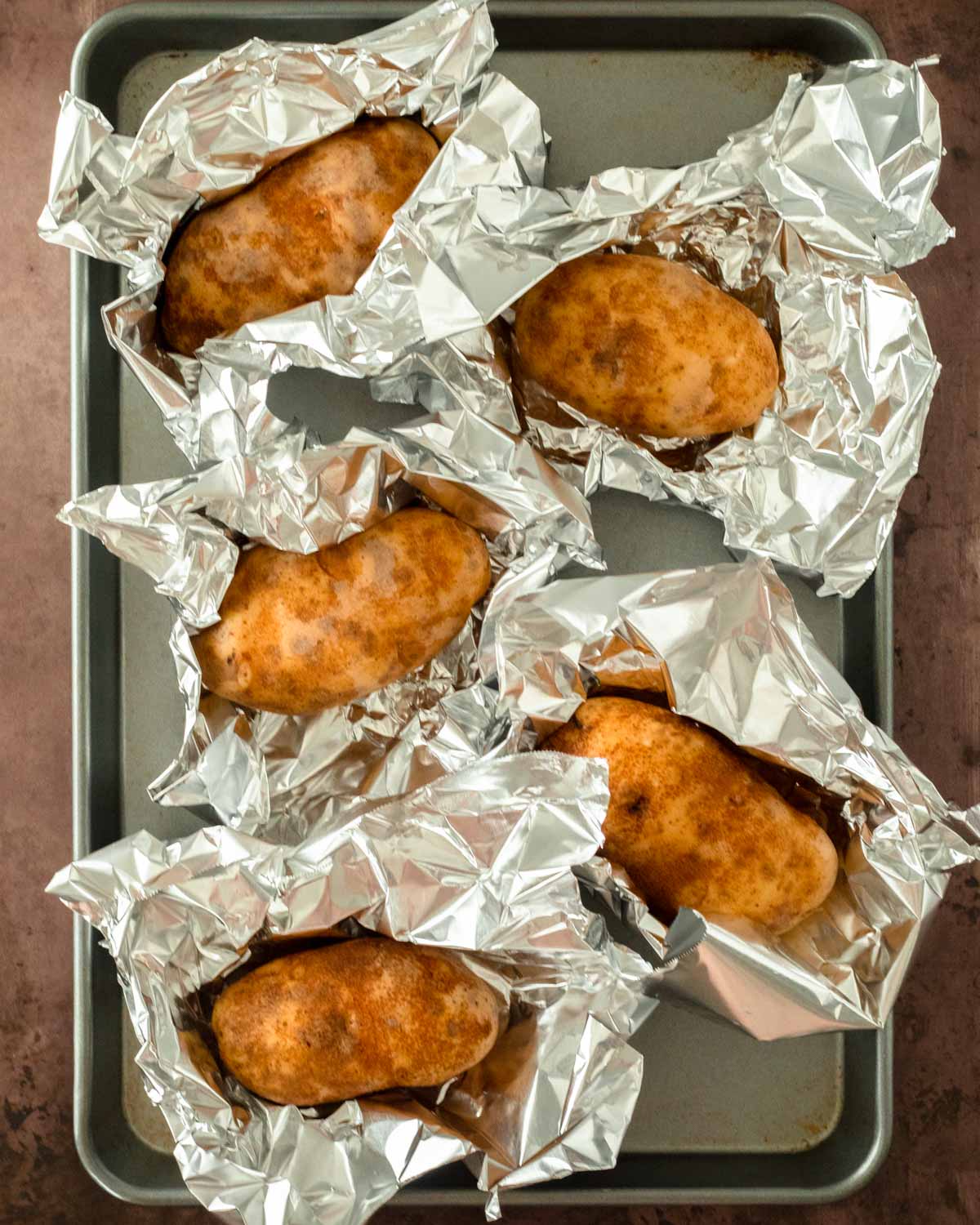 Step 1. Wrap the potatoes in foil and bake in the oven