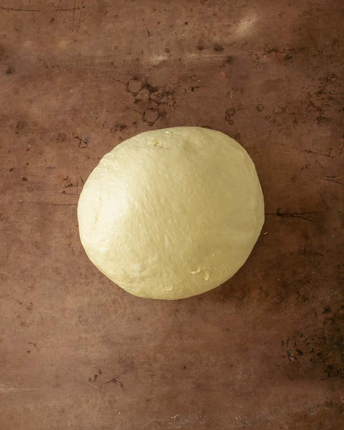 Step 15. Push the dough away then pull it back to form a ball. Rest 20 minutes then repeat the shaping process