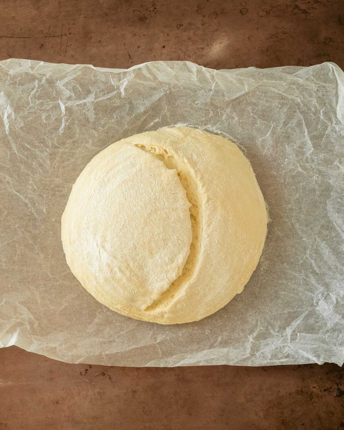 Step 17. Flip the dough onto parchment paper then score