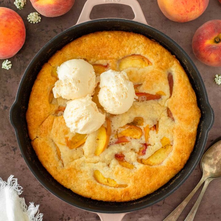 This peach cobbler is an easy summer dessert recipe that combines fresh-picked peaches with a creamy batter to make a delicious one-skillet dessert.