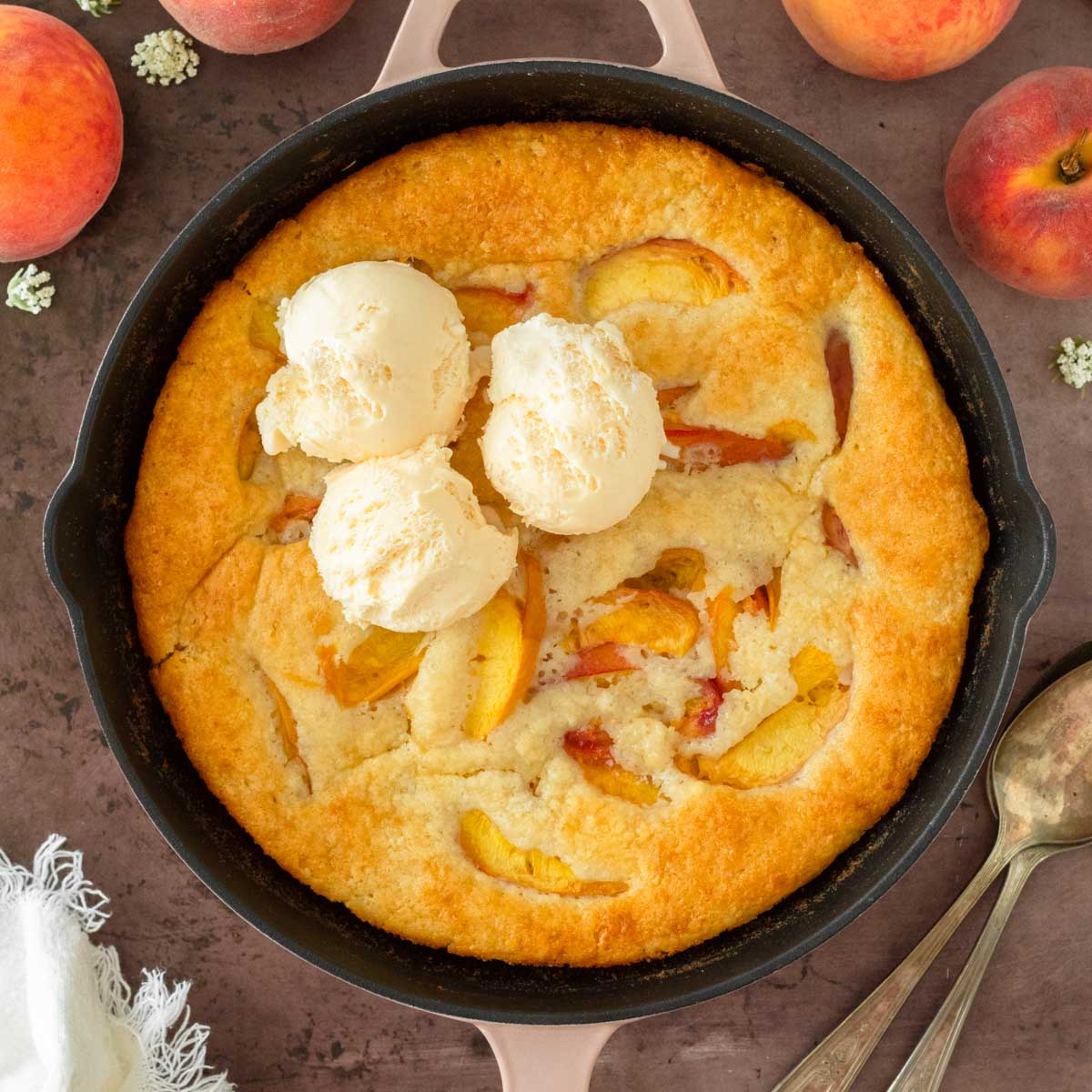 This peach cobbler is an easy summer dessert recipe that combines fresh-picked peaches with a creamy batter to make a delicious one-skillet dessert.