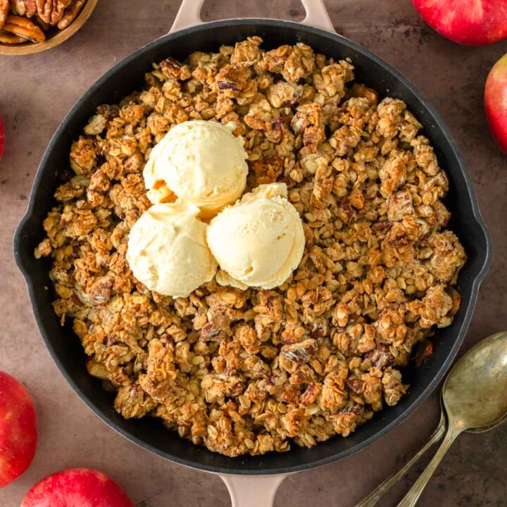 This skillet apple crisp is a classic fall dessert made with freshly picked apples tossed in maple syrup and cinnamon and baked in a skillet with a flavorful crisp topping.