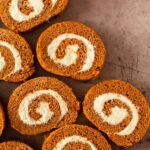 This pumpkin roll recipe is a simple pumpkin cake recipe filled with a homemade cream cheese frosting and rolled into a perfect spiral. This pumpkin roll cake with cream cheese filling is the perfect fall dessert and great for the holidays.