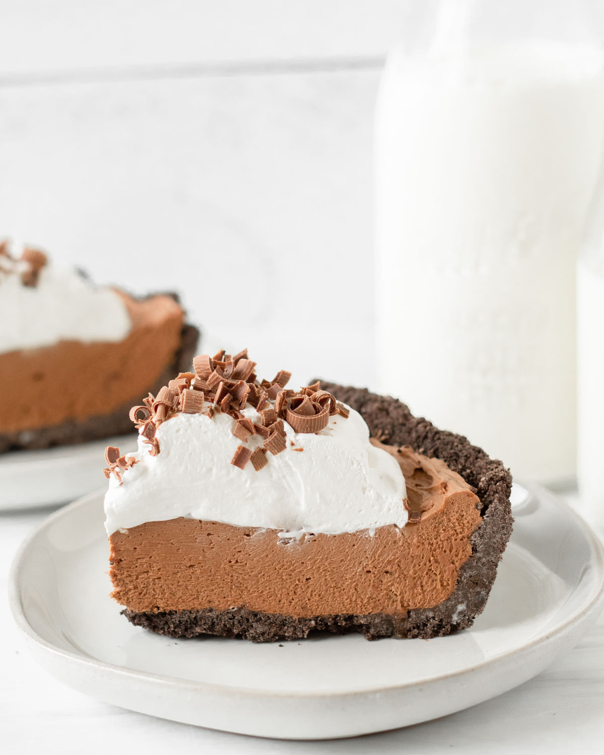 This French Silk Pie is a decadent chocolate pie recipe made with a chocolate crust, rich chocolate mousse filling and whipped cream topping. This homemade pie is our favorite holiday dessert recipe for Thanksgiving and Christmas.