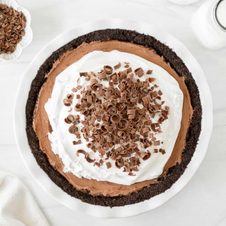 This French Silk Pie is a decadent chocolate pie recipe made with a chocolate crust, rich chocolate mousse filling and whipped cream topping. This homemade pie is our favorite holiday dessert recipe for Thanksgiving and Christmas.