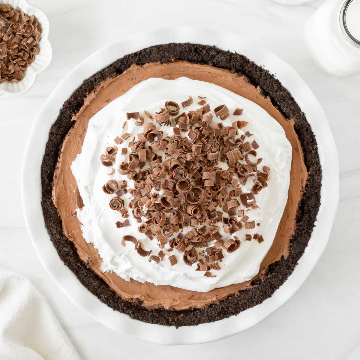 This French Silk Pie is a decadent chocolate pie recipe made with a chocolate crust, rich chocolate mousse filling and whipped cream topping. This homemade pie is our favorite holiday dessert recipe for Thanksgiving and Christmas.