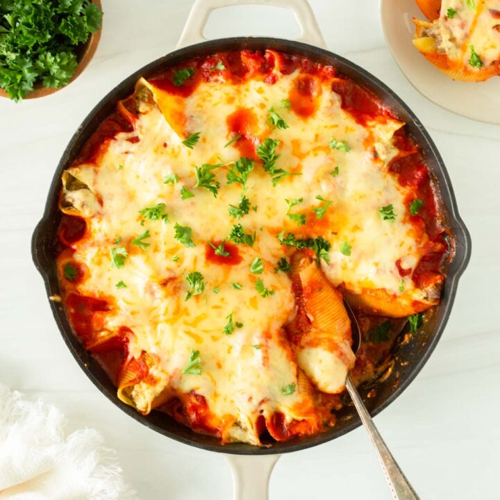 This recipe for lasagna stuffed shells is an easy one-skillet dinner recipe made with jumbo shells stuffed with classic lasagna ingredients and baked in the oven.