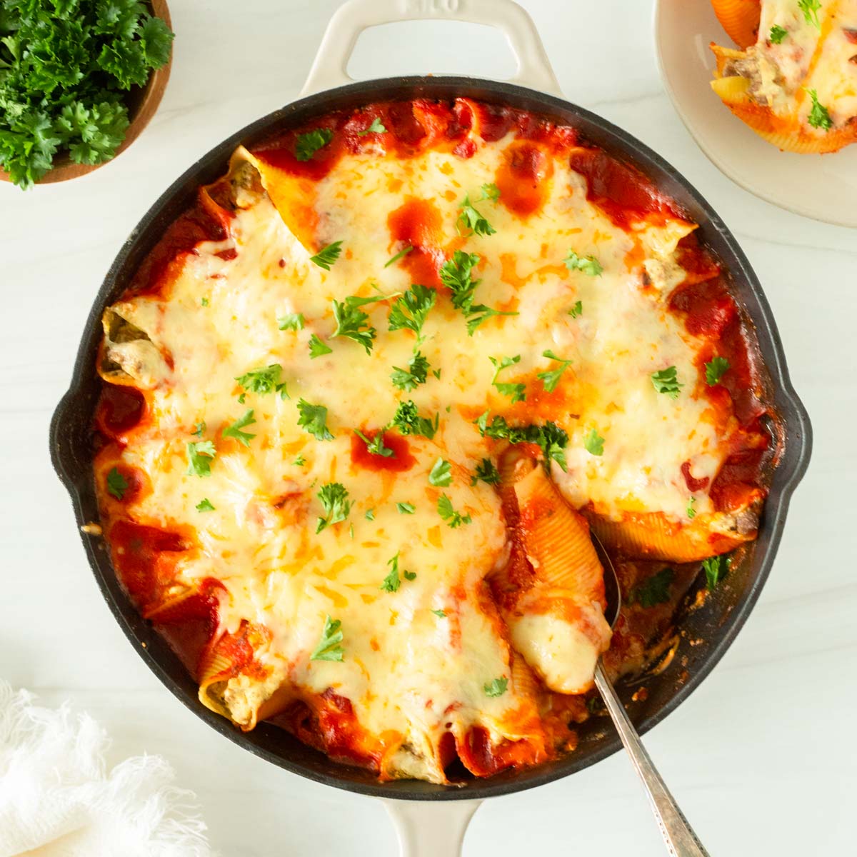 This recipe for lasagna stuffed shells is an easy one-skillet dinner recipe made with jumbo shells stuffed with classic lasagna ingredients and baked in the oven.