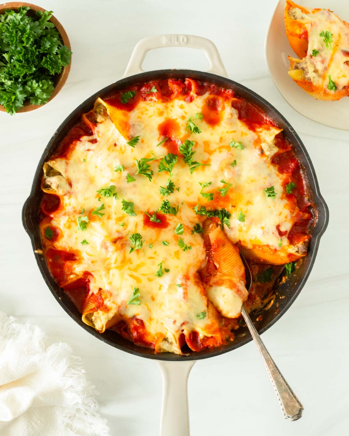 This recipe for lasagna stuffed shells is an easy one-skillet dinner recipe made with jumbo shells stuffed with classic lasagna ingredients and baked in the oven.