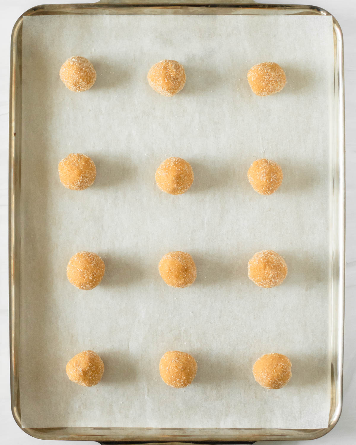Step 3. Shape into balls, roll in sugar and place on a sheet pan
