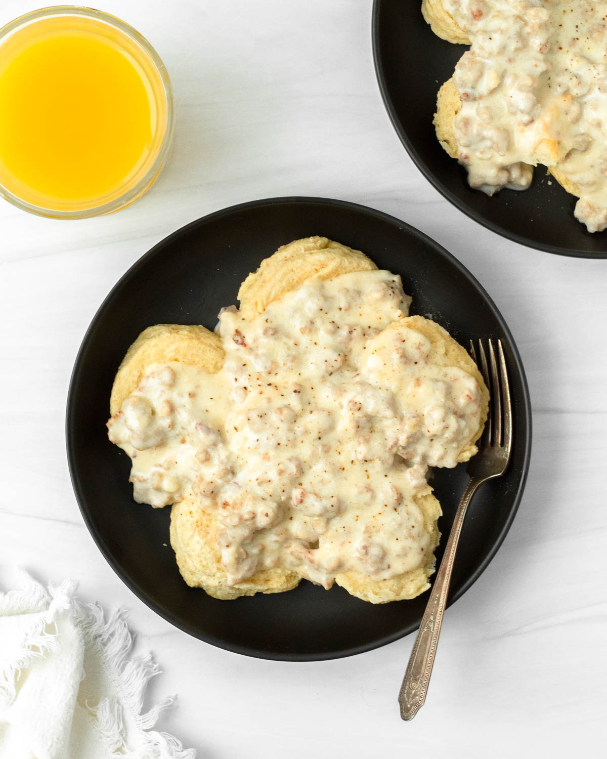 This biscuits and gravy recipe is a classic comfort food breakfast recipe made with a thick sausage gravy served over flaky buttery biscuits.