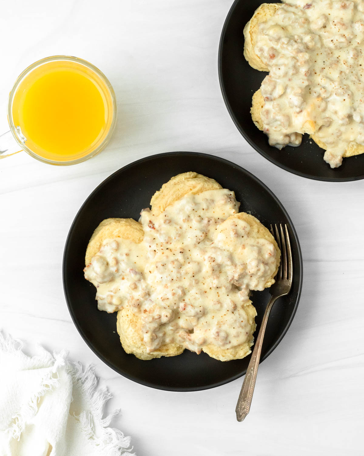 This biscuits and gravy recipe is a classic comfort food breakfast recipe made with a thick sausage gravy served over flaky buttery biscuits.