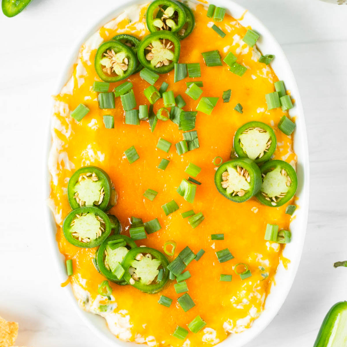 This jalapeno popper dip is a great game day appetizer and one of our favorite Super Bowl Sunday appetizer recipes. Made with classic jalapeno popper ingredients, this easy dip recipe is ready in 15-minutes for a quick and easy crowd-pleaser appetizer.